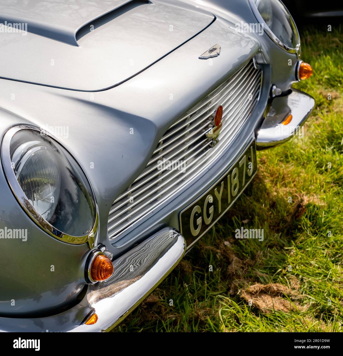 Earsham, Norfolk, UK – April 30 2023. Close up of the front end, including headlights, grille and bonnet, of a fully restored Aston Martin DB6 sports Stock Photo