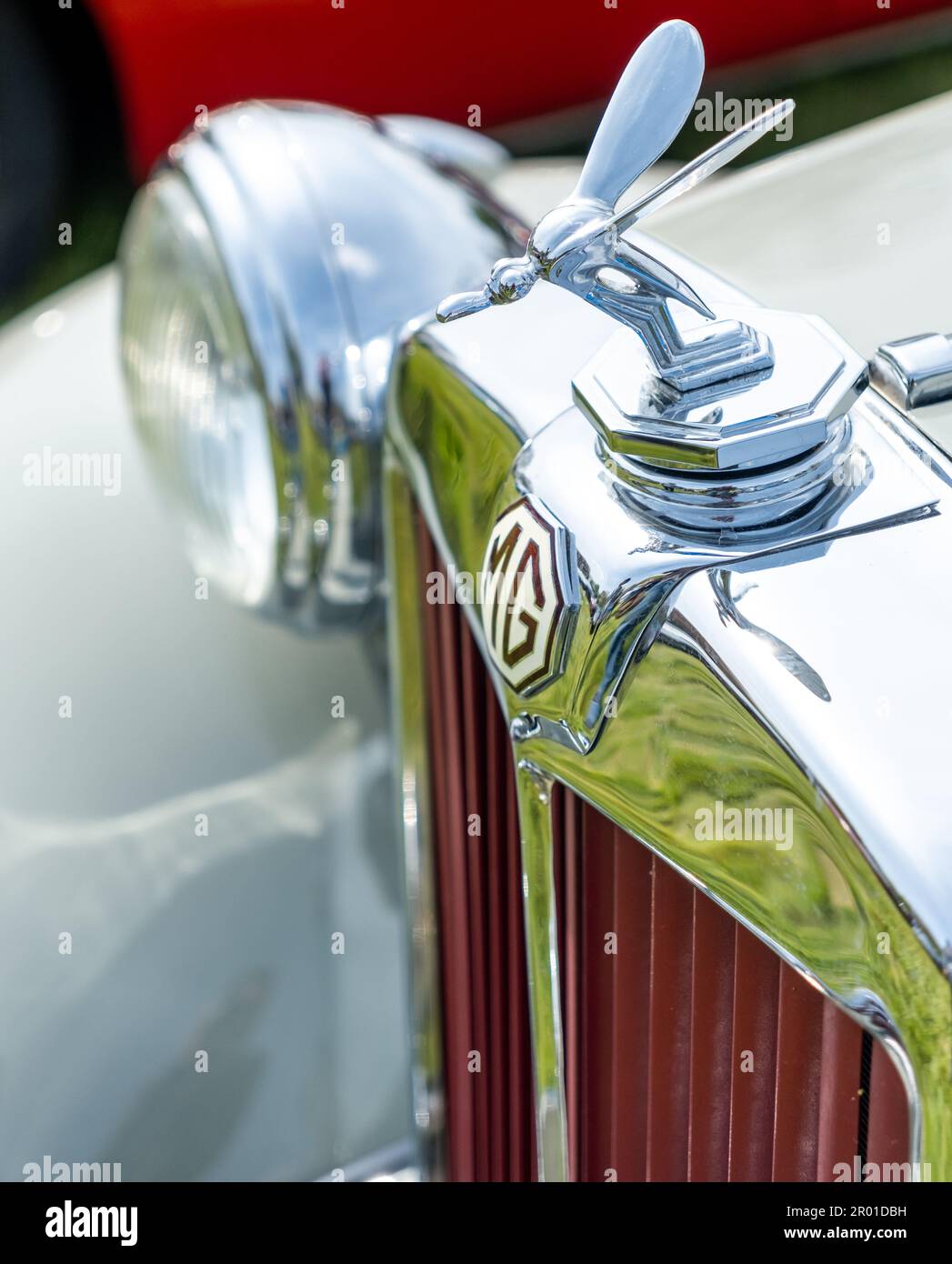 Earsham, Norfolk, UK – April 30 2023. Close and selective focus on the bonnet ornament on a fully restored classic MG sports car on display at a small Stock Photo