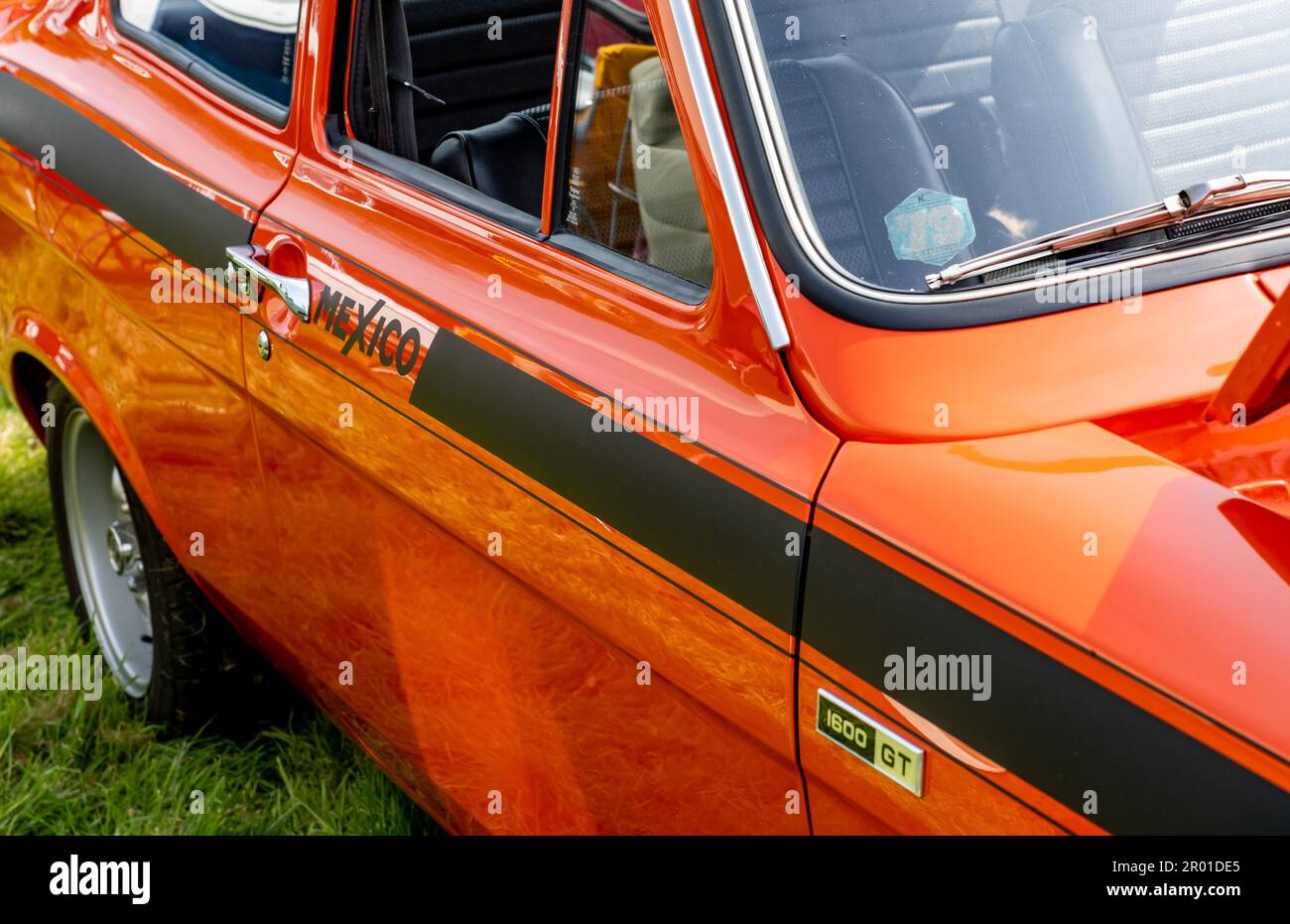 Earsham, Norfolk, UK – April 30 2023. Side on view of a fully restored Mk1 Ford Escort Mexico rally car on display at a small and local outdoor car sh Stock Photo