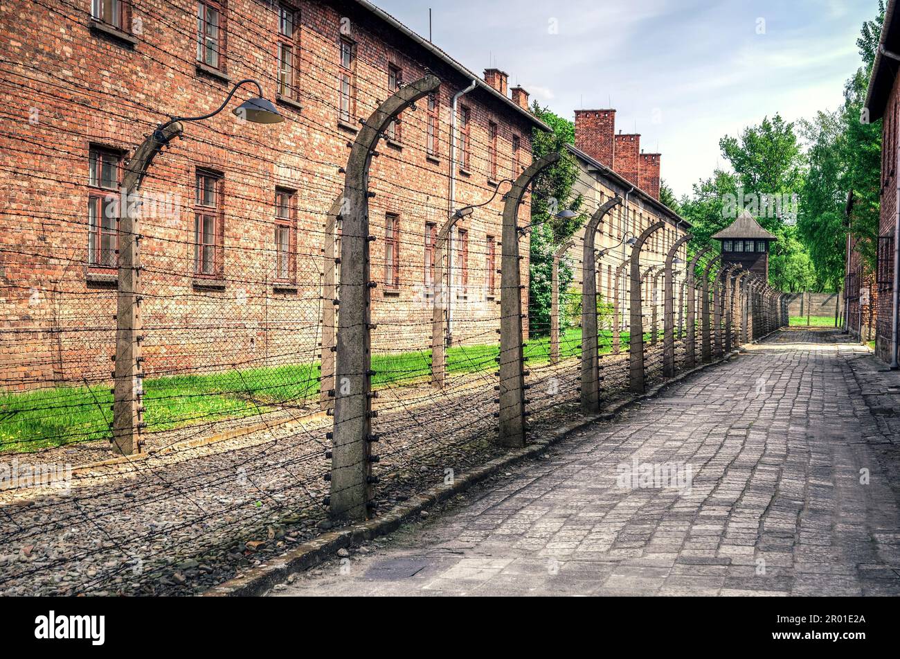 Oswiecim, Poland - May 12, 2016: Masonry block and fence with barbed wire in concentration camp Auschwitz-Birkenau in Oswiecim, Poland. Stock Photo