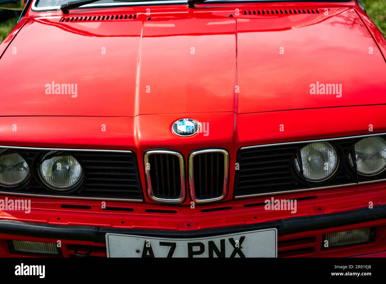 Earsham, Norfolk, UK – April 30 2023. Close up of the front end including bonnet, badge, grille and headlights of a classic series 3 BMW saloon car on Stock Photo