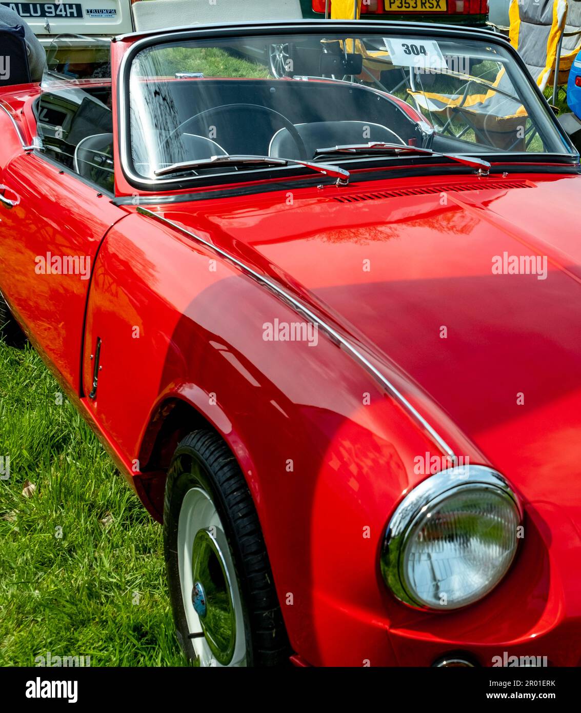Earsham, Norfolk, UK – April 30 2023. Front and side on view of a classic MG convertible sports car on display at a small and local outdoor car show Stock Photo
