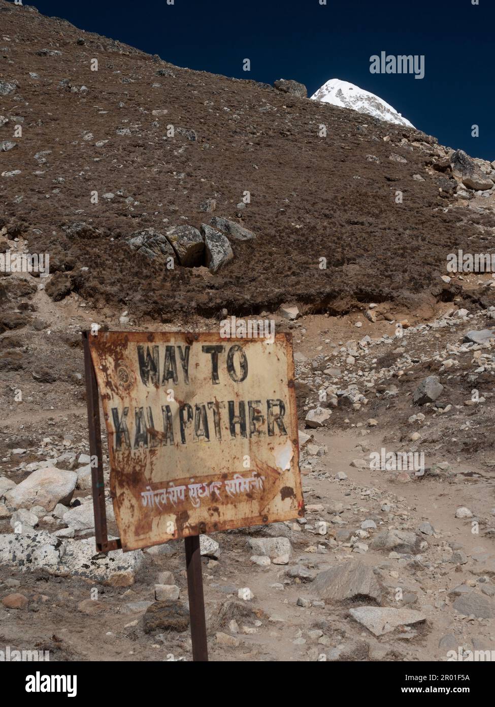 Nepal. Old sign showing the direction of Kala Pattar view point with Pumori mountain in the background. Stock Photo