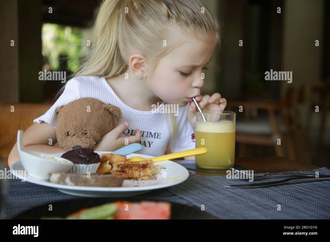Cute 5 years old girl having kids meal at the restaurant Cute 5 years old girl having kids meal at the restaurant Stock Photo
