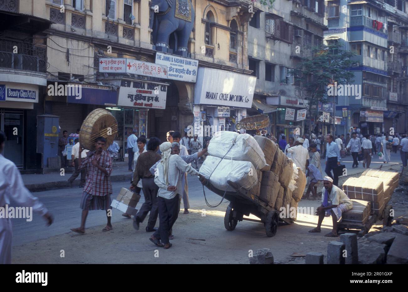 a marketstreet and road with traffic and People in the city centre of ...