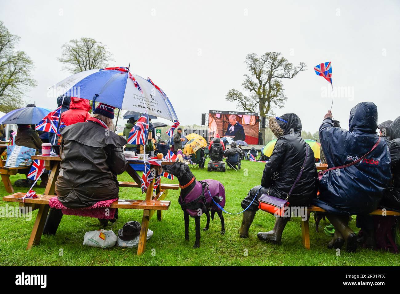 Badminton, UK. 6th May, 2023.  The spectators at the Badminton Horse Trials presented by MARS Equestrian watch the Coronation on the screens, in the Parkland of Badminton House in the village of Badminton in Gloucestershire, UK.   Credit: Peter Nixon / Alamy Live News Stock Photo
