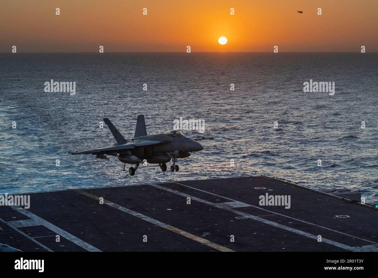 USS Nimitz, International Waters. 03 May, 2023. A U.S. Navy F/A-18E Super Hornet fighter aircraft from the Blue Diamonds of Strike Fighter Squadron 146, approaches for an arrested landing on the flight deck of the Nimitz-class aircraft carrier USS Nimitz underway at sunset conducting routine operations, May 3, 2023 in the South China Sea.  Credit: MC2 David Rowe/U.S Navy Photo/Alamy Live News Stock Photo