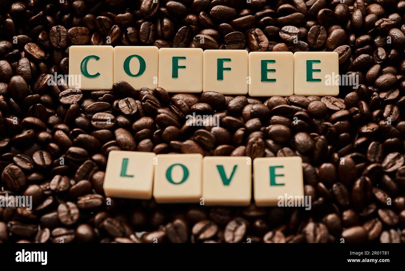 Coffee is my one true love. Closeup shot of block letters forming the words coffee love on a pile of coffee beans. Stock Photo