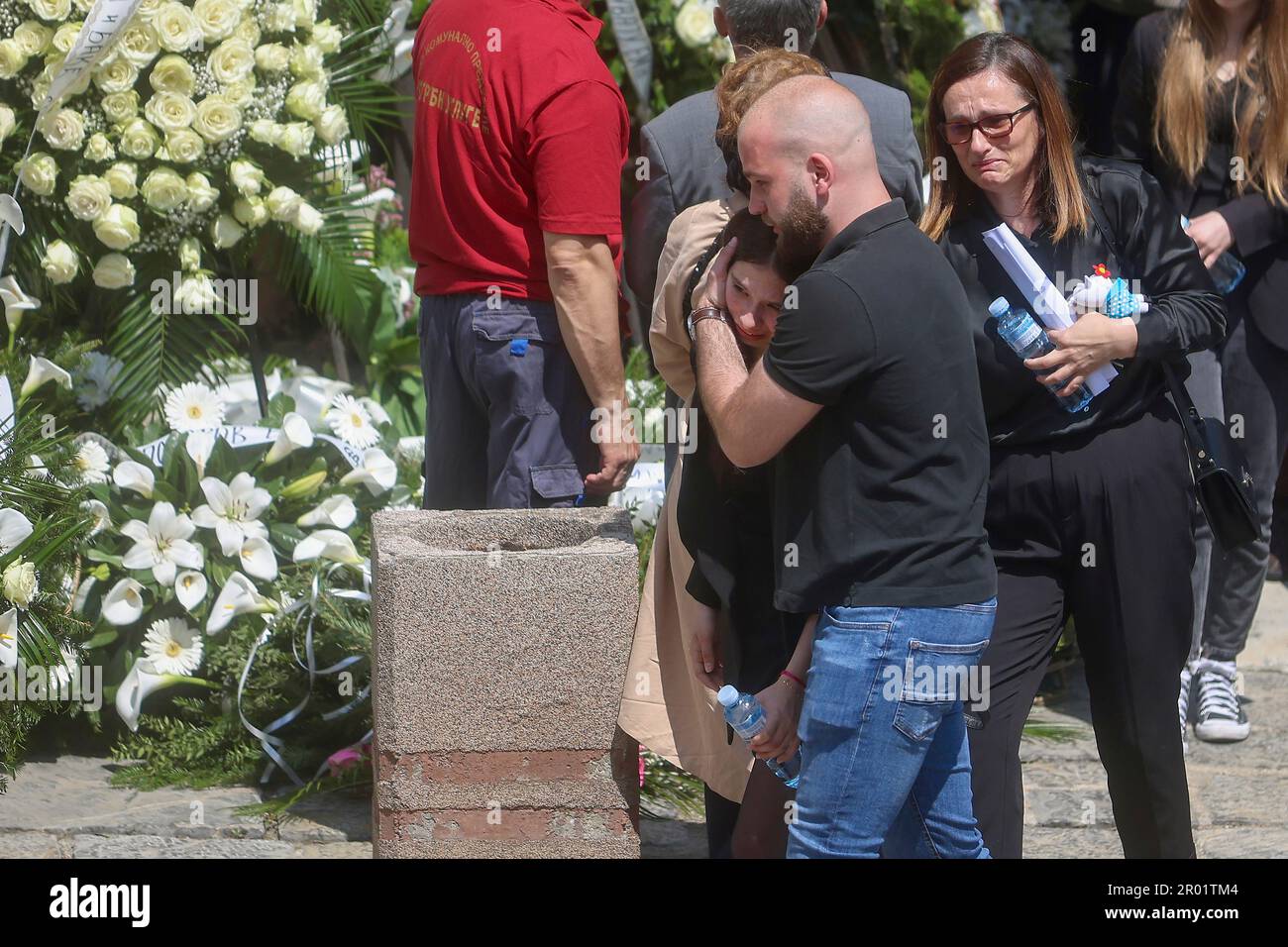 People mourn during the funeral procession of a girl Ema Kobiljski,13, at  the central cemetery in Belgrade, Serbia, Saturday, May 6, 2023. Her  schoolmate, a 13-year-old boy, on Wednesday, used his fathers