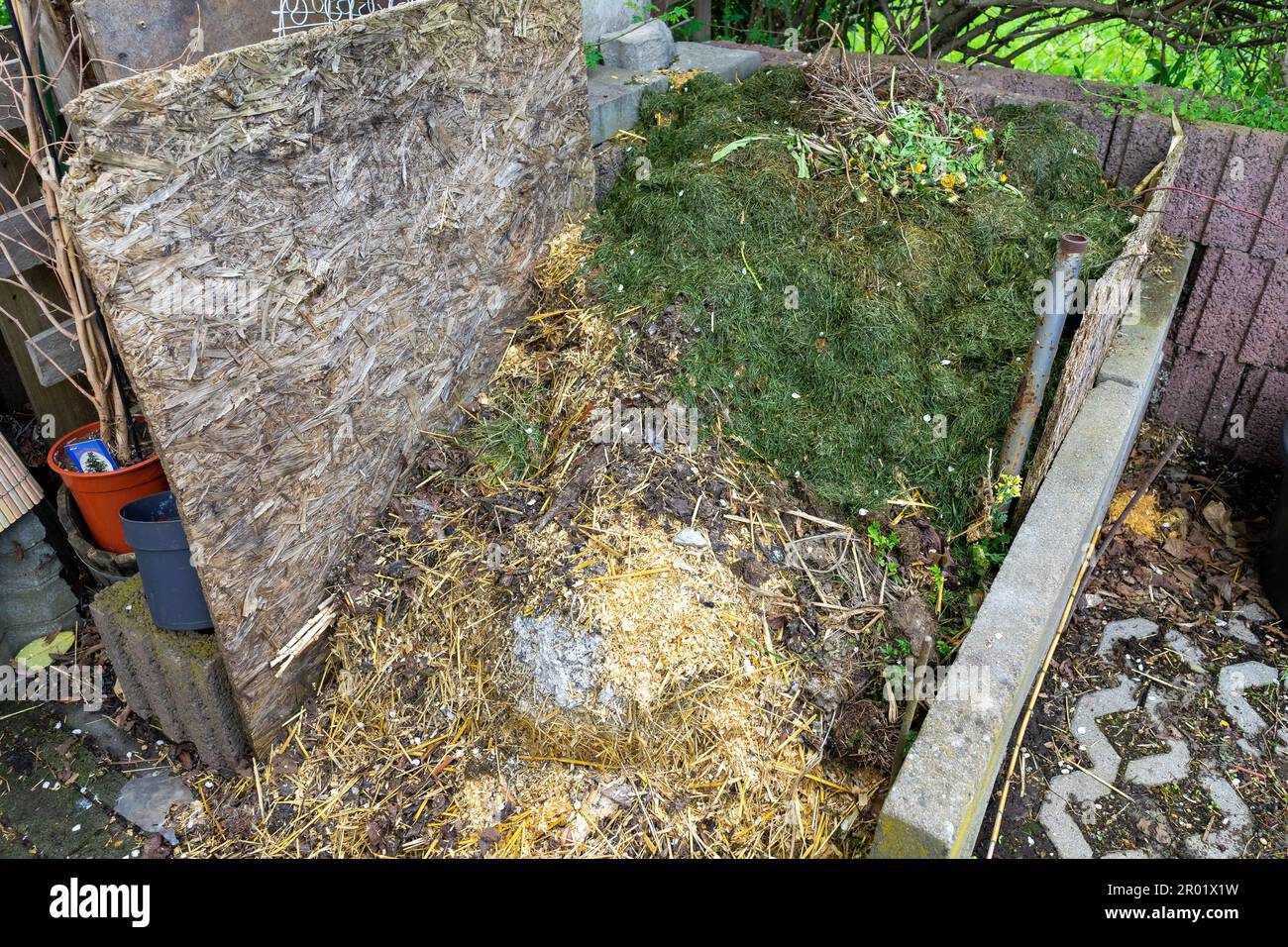 Garden waste on a composter in the garden Stock Photo