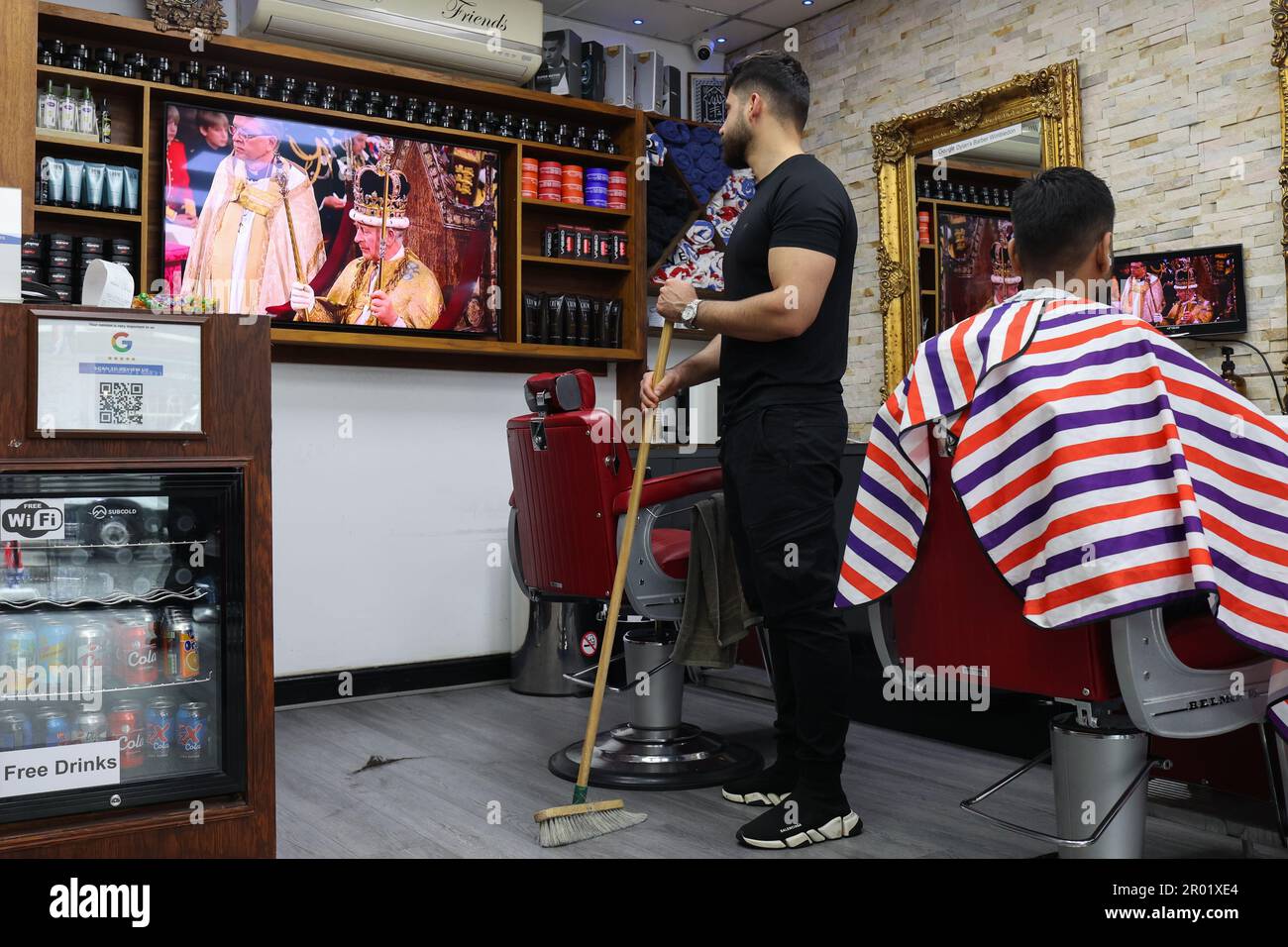 London, UK. May 6, 2023. A TV screen shows the Coronation of King