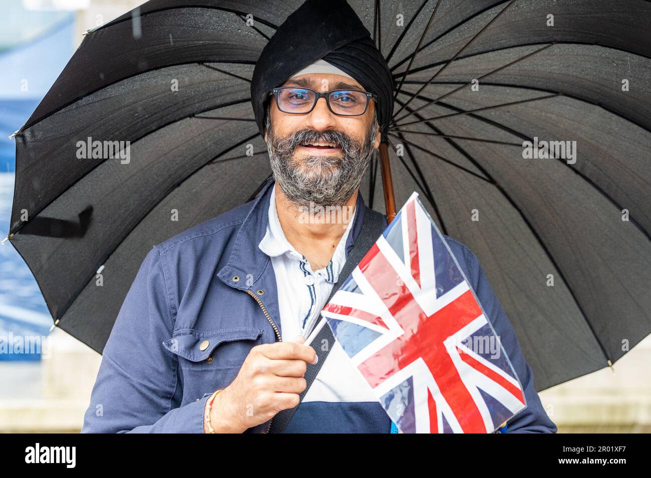 Coventry, West Midlands, UK. 6th May, 2023. People around the country came out to celebrate the coronation of King Charles III today. Mandip Singh Seehra gets into the spirit of the day in Broadgate, Coventry City Centre. Credit: AG News/Alamy Live News Stock Photo