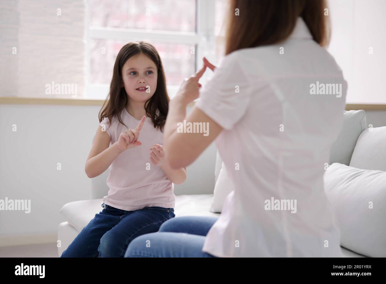Child Learning Sign Language. Hearing Disabilities And Audiology Stock