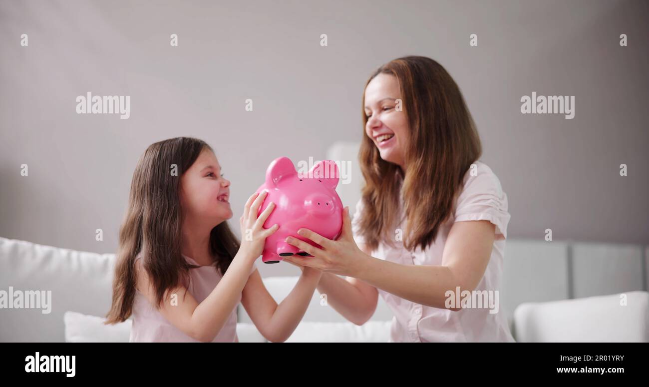 Mom and daughter saving money hi-res stock photography and images - Alamy