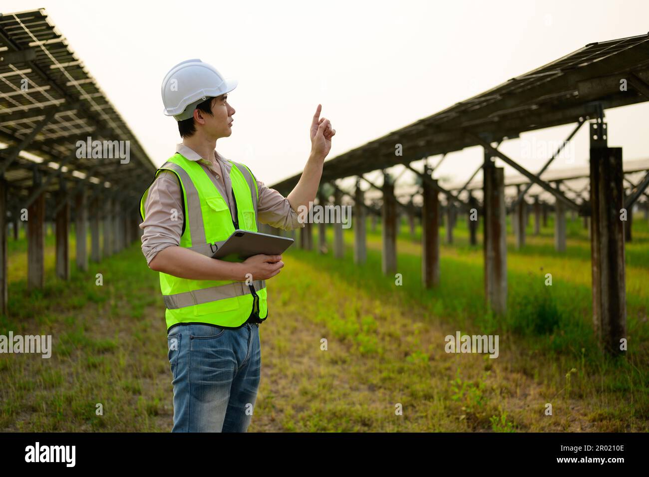 Maintenance engineer installing solar panels on solar cell farm Stock ...