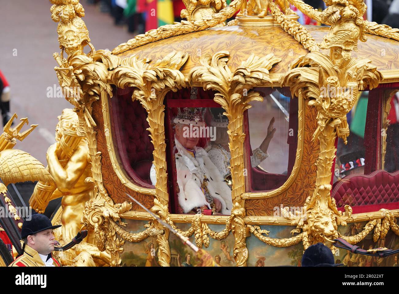 King Charles III and Queen Camilla are carried in the Gold State Coach, pulled by eight Windsor Greys, in The Coronation Procession as they return along The Mall to Buckingham Palace, London, following their coronation ceremony. Picture date: Saturday May 6, 2023. Stock Photo