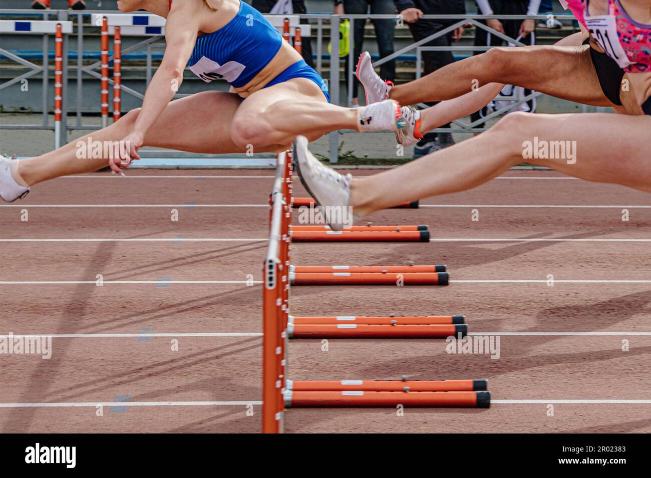 leading woman runner headed running hurdles race in summer athletics