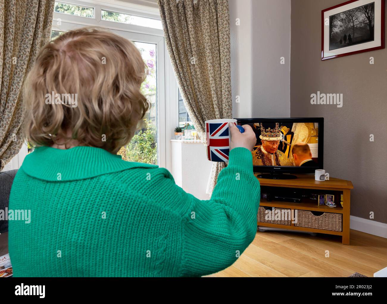 Woman watching the coronation on television hi-res stock photography ...