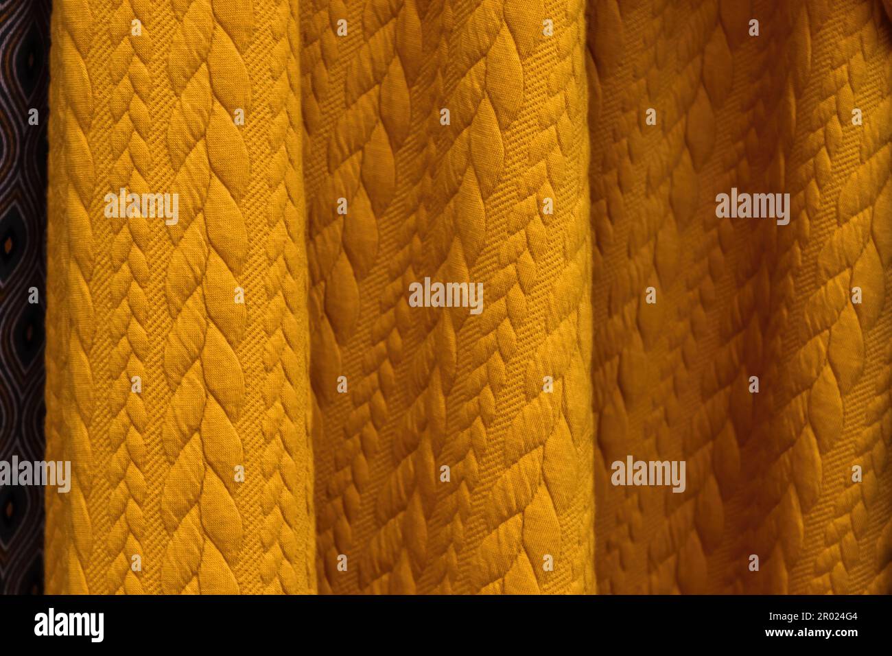 Detailed close up view on samples of cloth and fabrics in different colors found at a fabrics market. Stock Photo