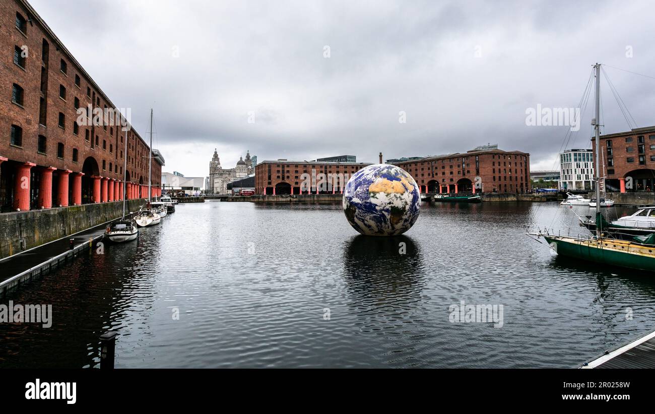 Floating Earth Artwork and visitors at Liverpool's Albert Dock Stock