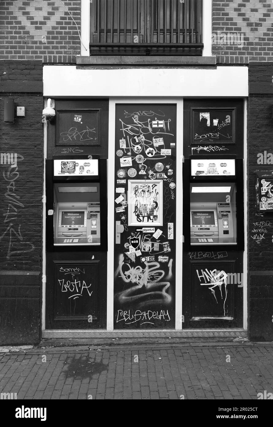 Black and white of graffiti defaced ATM cash points in Amsterdam, Netherlands. Stock Photo