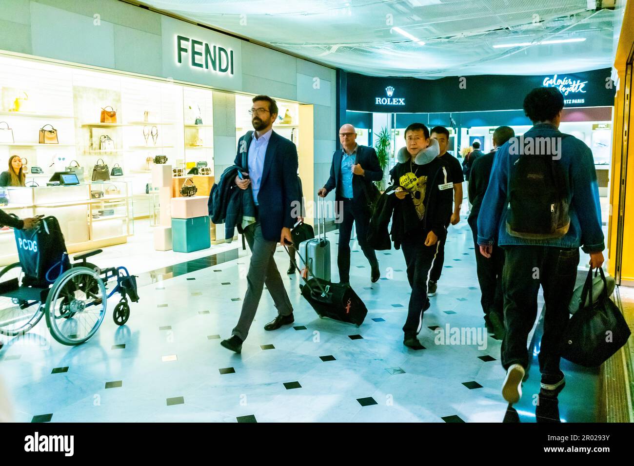 Roissy, France, Charles-de-Gaulle International Airport, Crowd People Travelling inside, Crowd Walking, Hallway,  Luxury Shops, Fendi Stock Photo