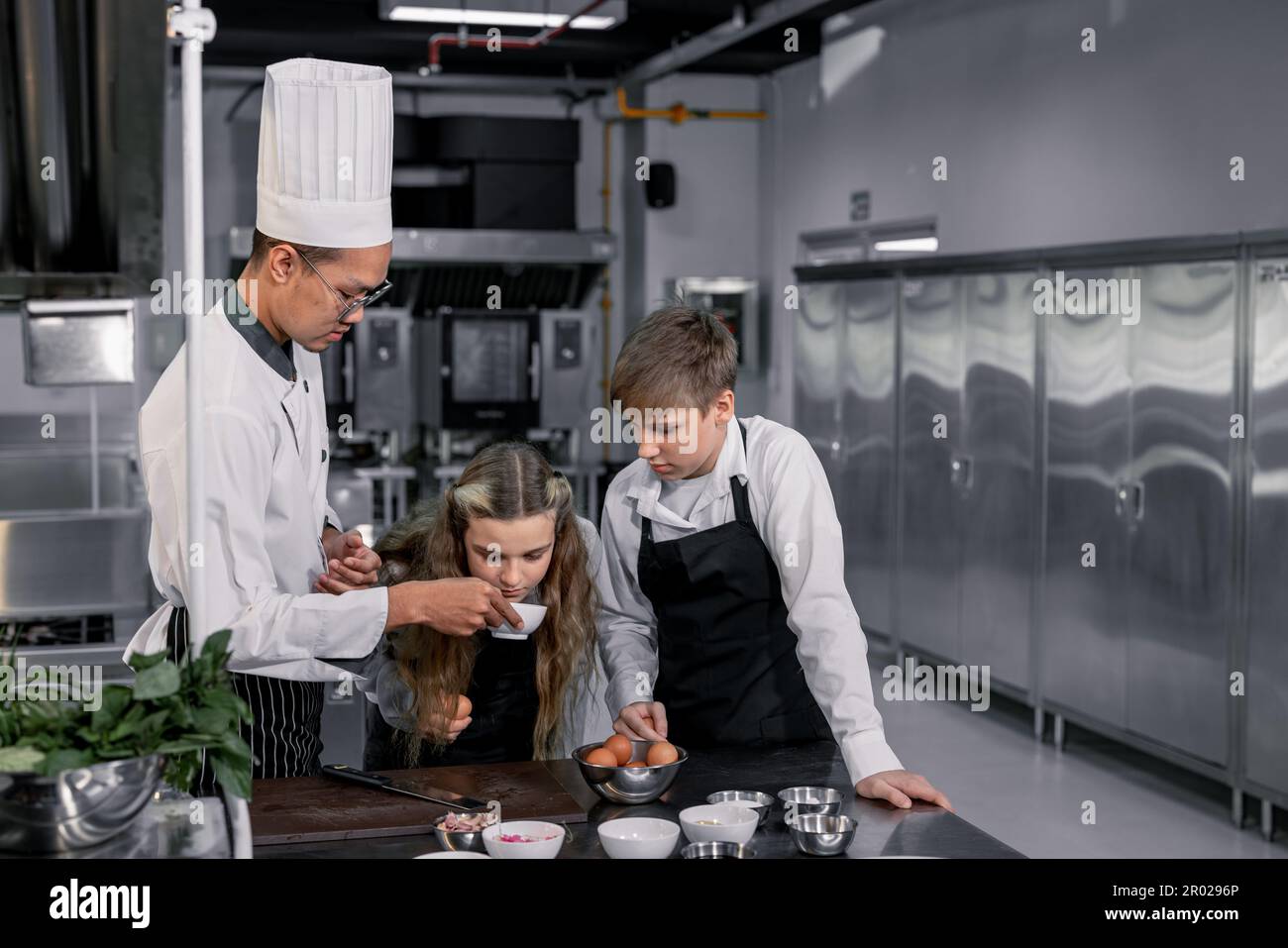 Teenagers learn from expert chefs at culinary school to prepare