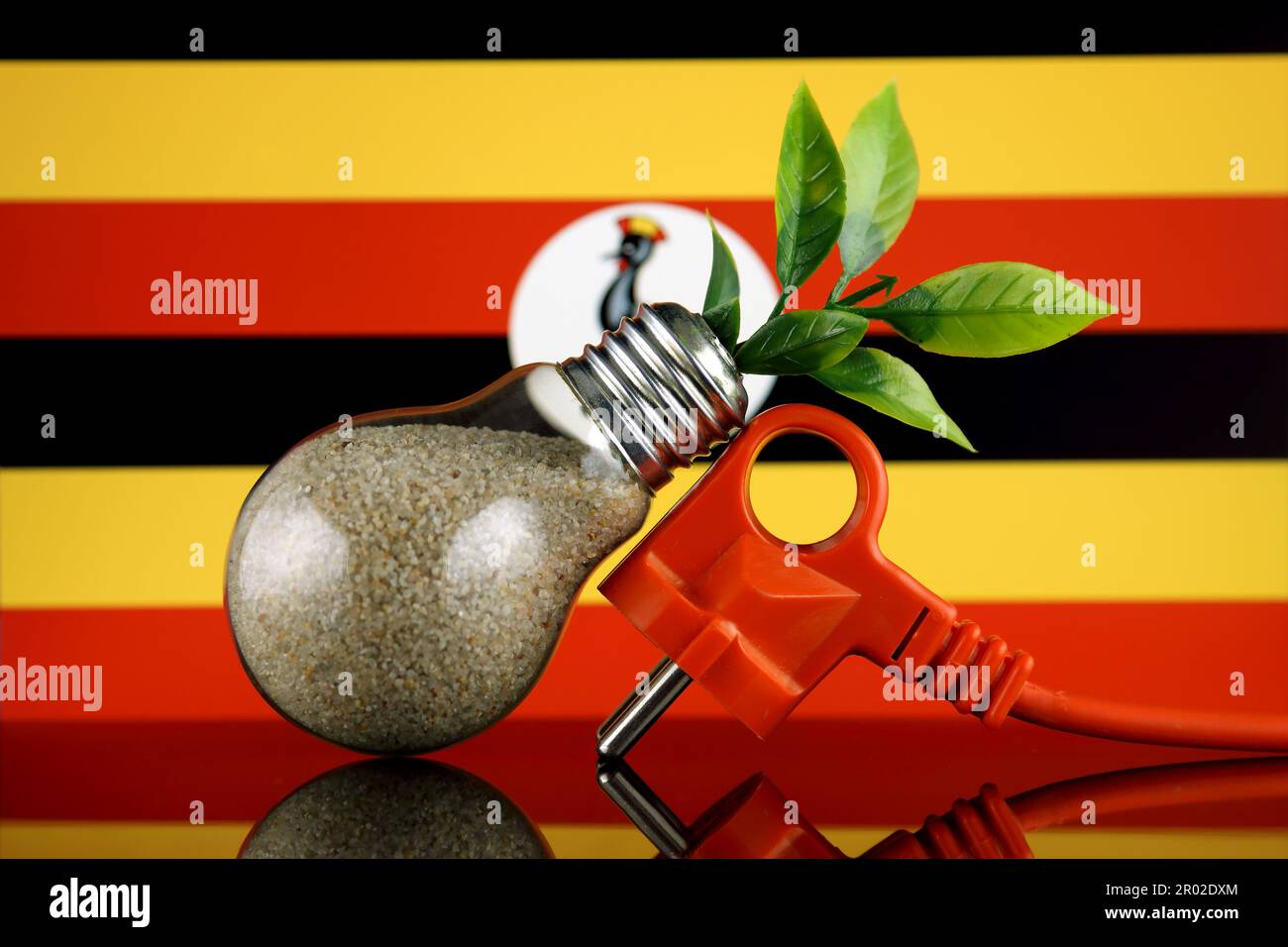 Plug, plant growing inside the light bulb and Uganda Flag. Green eco