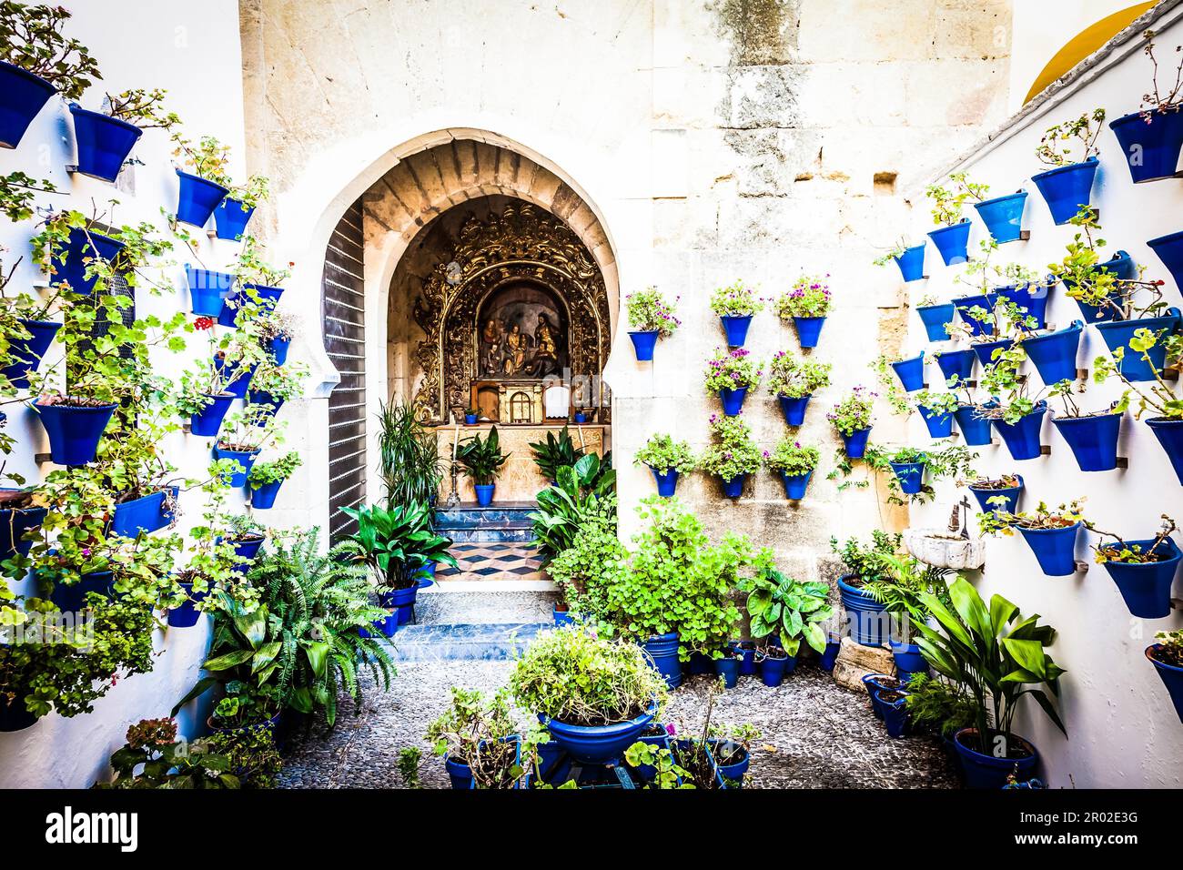 Cordoba, Andalusia Region, Spain. An old church with the traditional flowers set up of this town Stock Photo