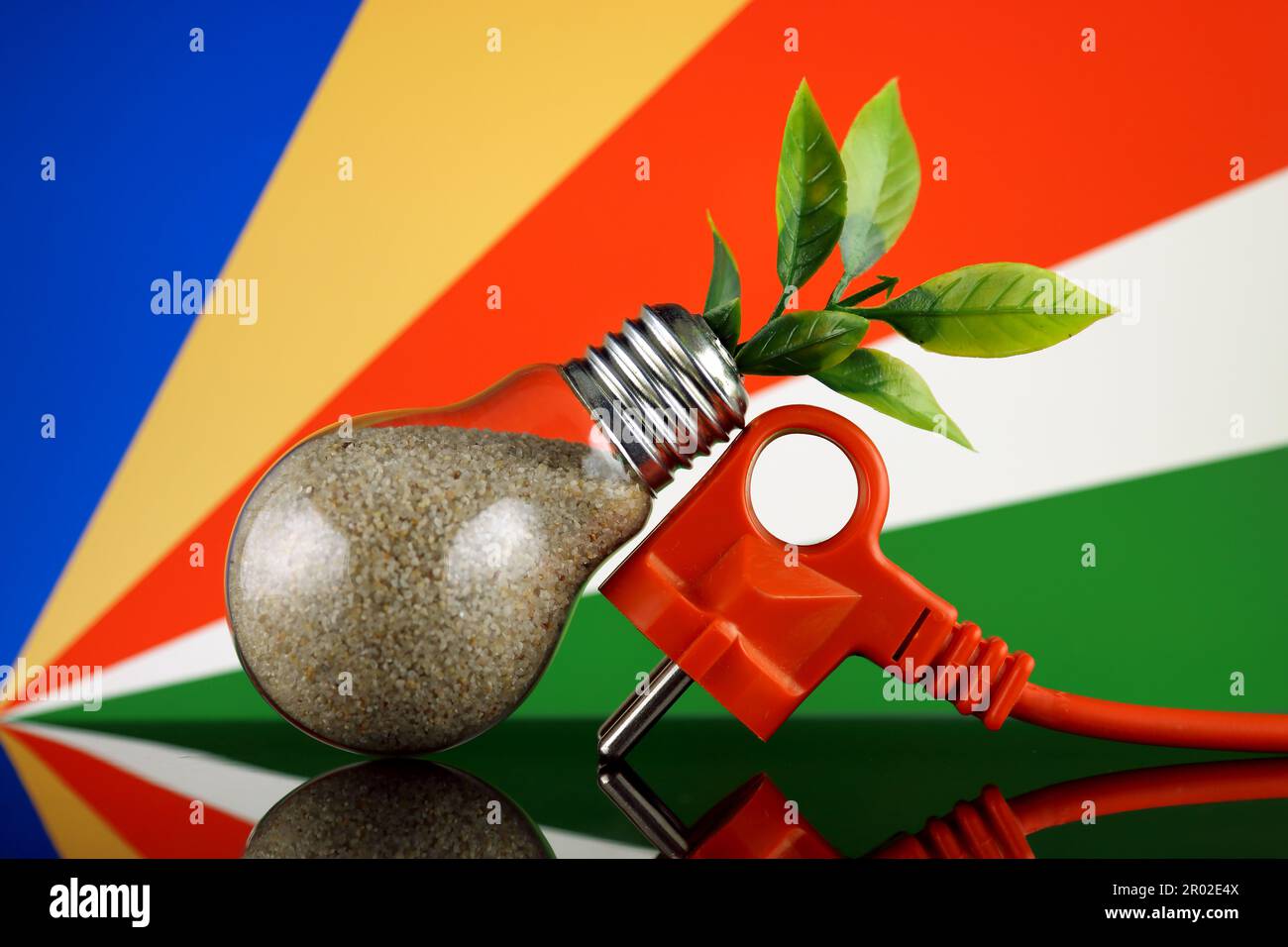 Plug, plant growing inside the light bulb and Seychelles Flag. Green