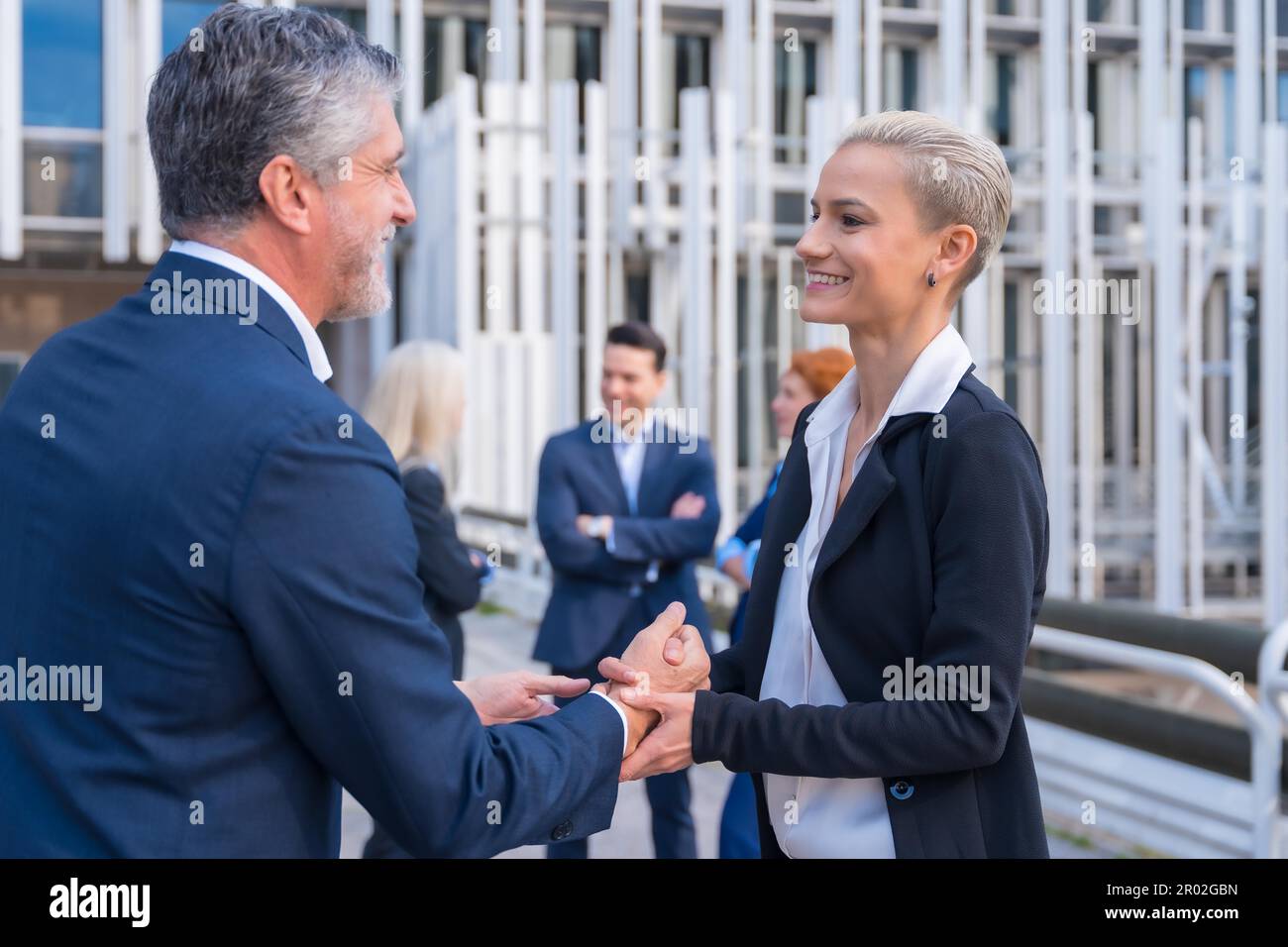 Business Leaders Shaking Hands in a Modern Metropolitan Setting Stock Photo