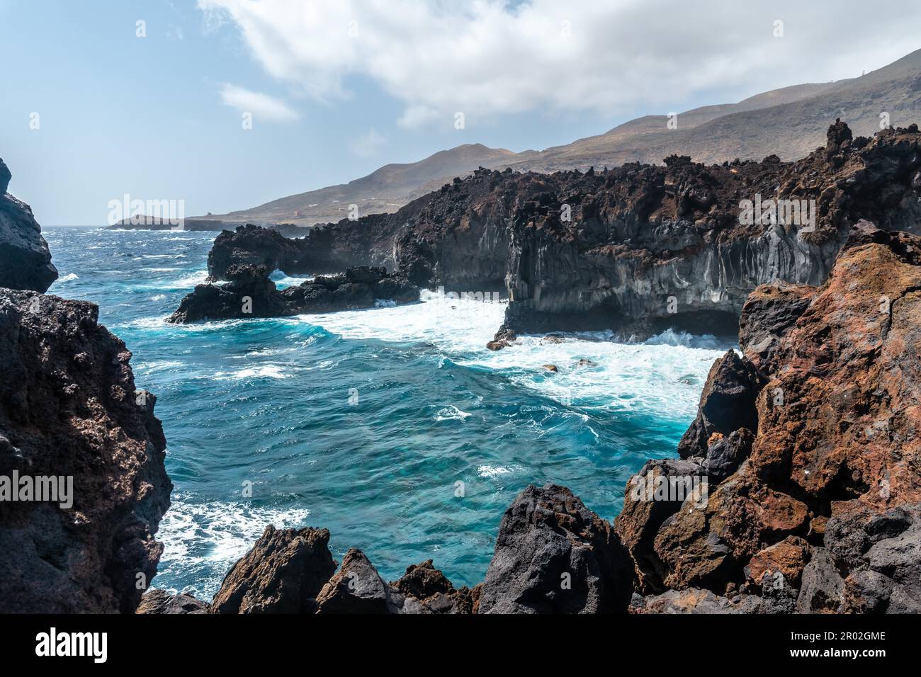 Views of the cliffs from the volcanic trail in the town of Tamaduste on the coast of the island of El Hierro, Canary Islands, Spain Stock Photo