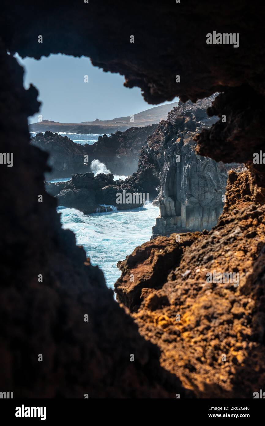 Cliffs from the volcanic trail in the village of Tamaduste on the coast of the island of El Hierro, Canary Islands, Spain. vertical photo Stock Photo