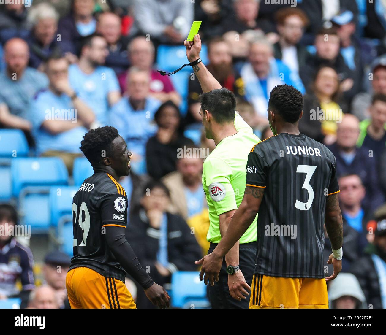 Referee Andrew Madley gives a yellow card to Wilfried Gnonto 29 of Leeds United during the