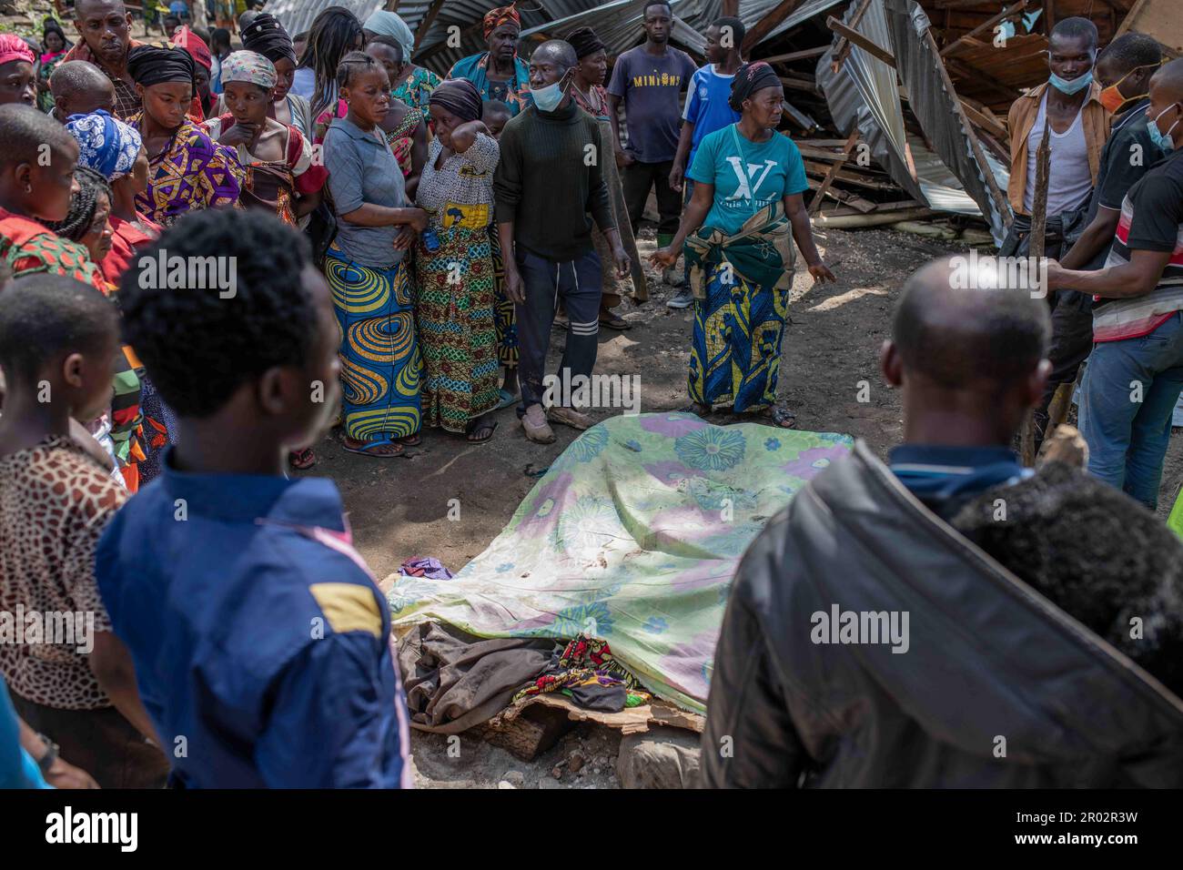 Villagers gather to identify victims in the village of Nyamukubi, South