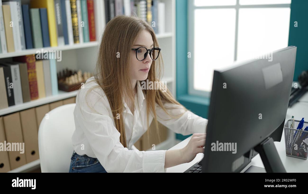 Blonde Computer Program Young blonde woman student using computer studying at university ...