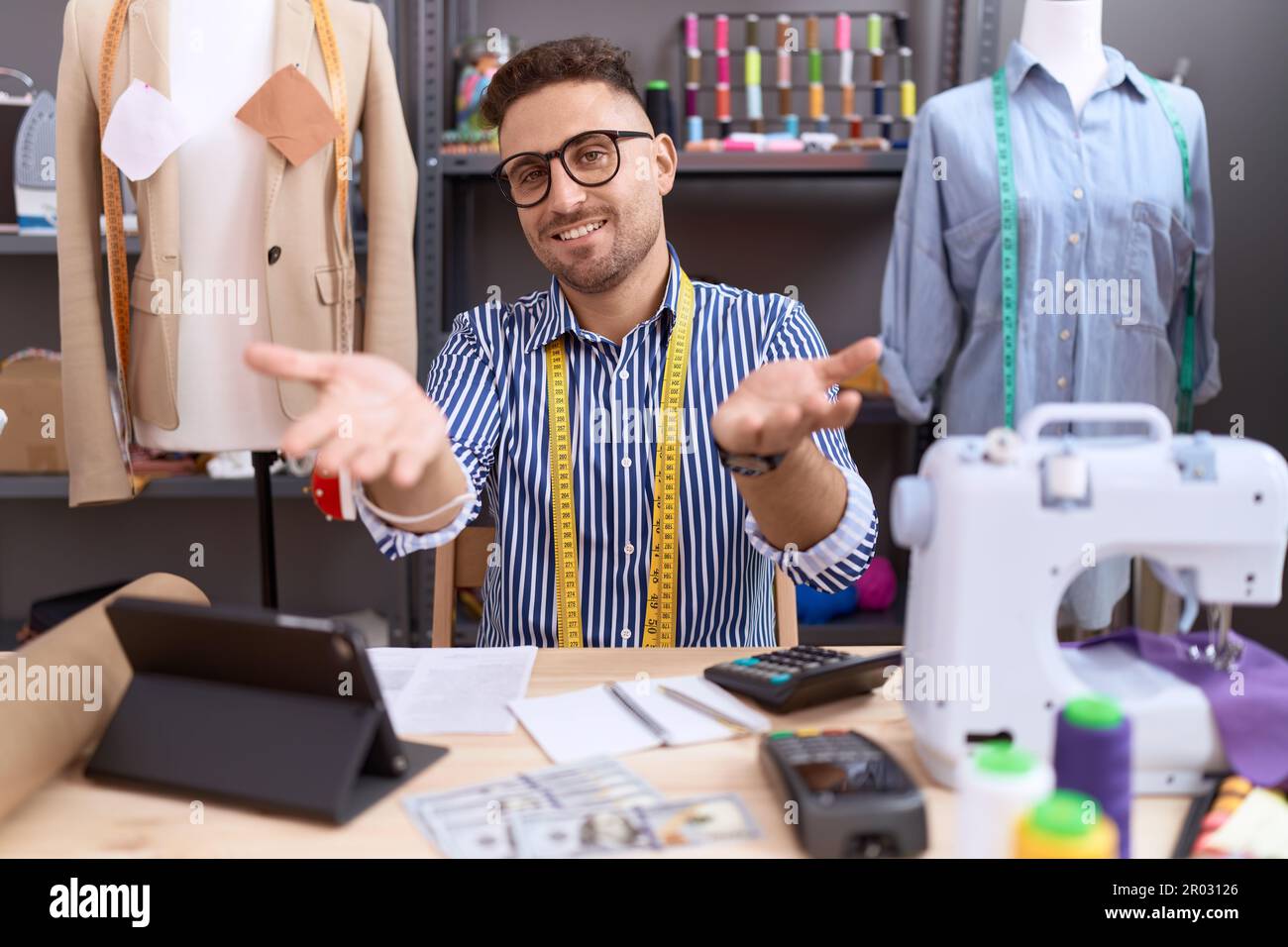 Hispanic man with beard dressmaker designer working at atelier smiling ...