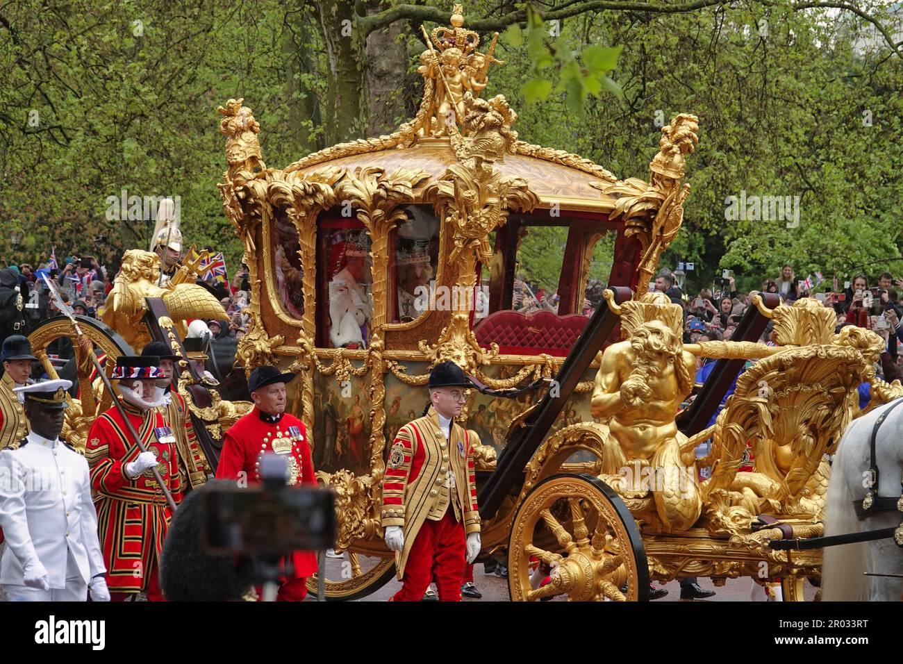 Westminster, London, UK. 6th May, 2023. The ceremonial procession from Westminster Abbey by HRH King Charles lll and Queen Camilla, in the Golden State Coach, preceeded by HM Forces in full military regalia, watched by thousands of Royalists on The Mall Credit: Motofoto/Alamy Live News Stock Photo