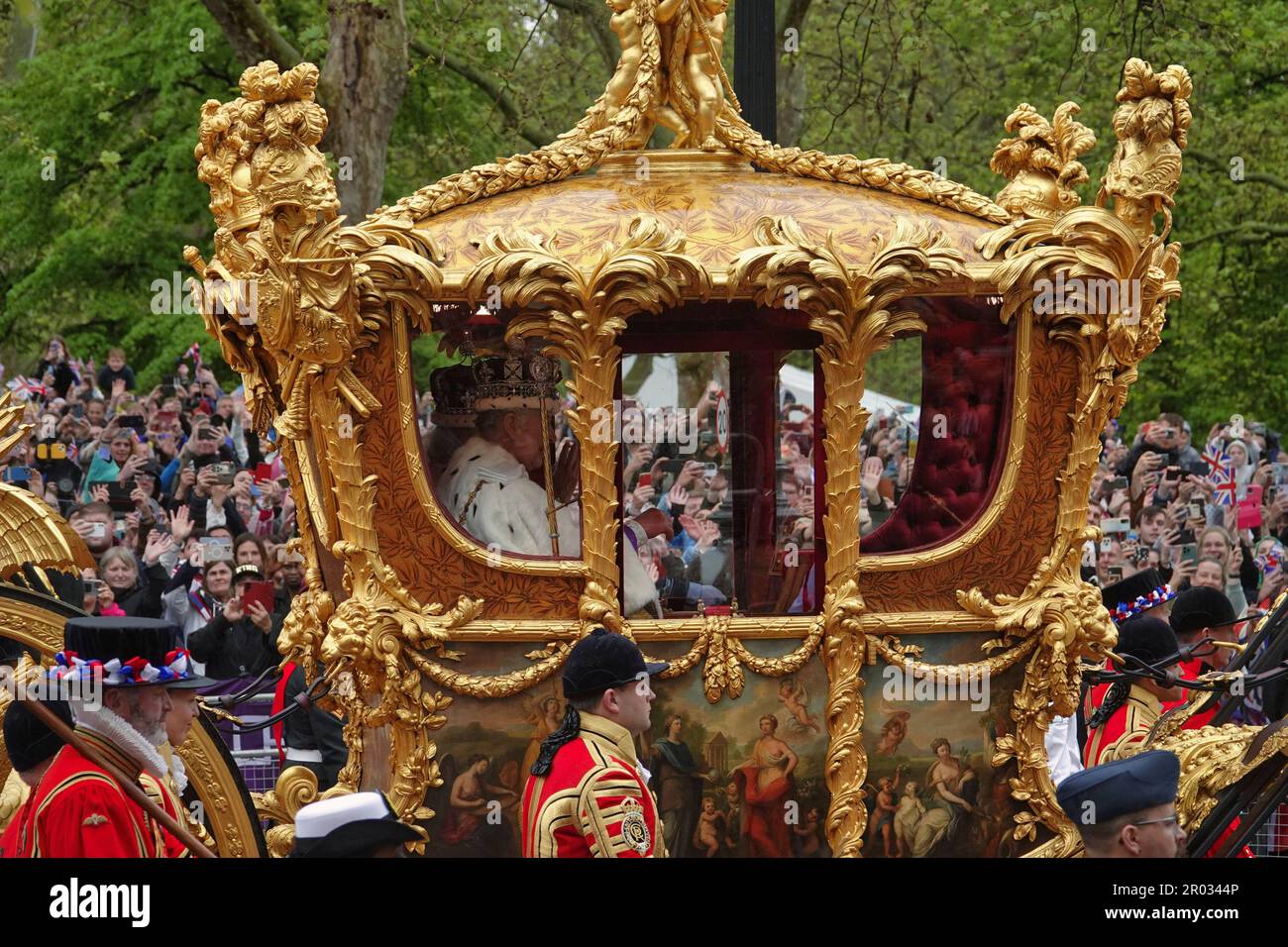 Westminster, London, UK. 6th May, 2023. The ceremonial procession from Westminster Abbey by HRH King Charles lll and Queen Camilla, in the Golden State Coach, preceeded by HM Forces in full military regalia, watched by thousands of Royalists on The Mall Credit: Motofoto/Alamy Live News Stock Photo
