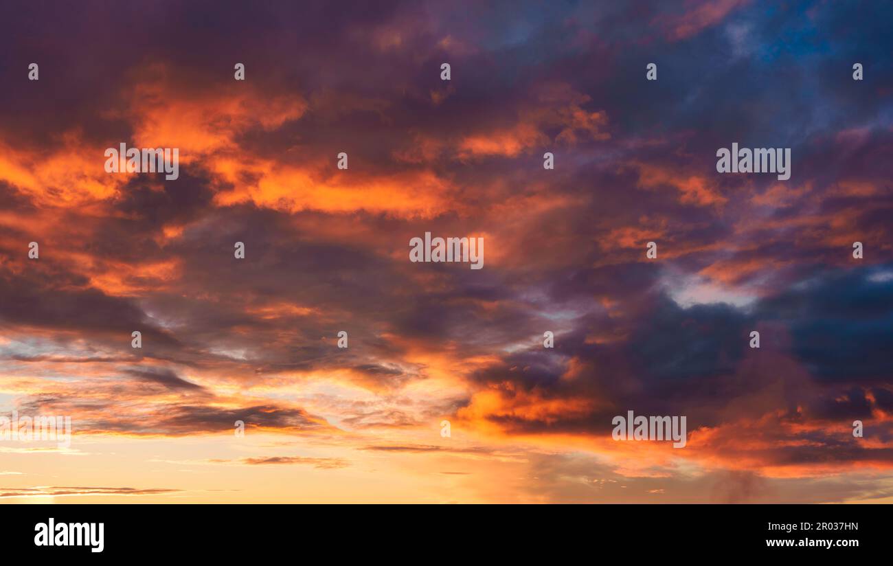 Colorful dark vibrant dramatic sunset with cloudy sky atmosphere Stock Photo