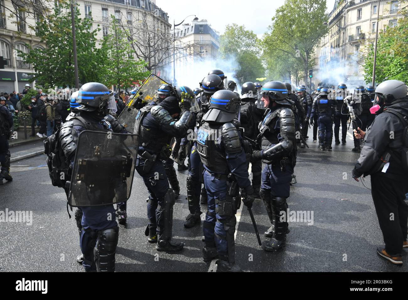 Paris,France,1st May 2023.International workers day. Thousands of people protested and celebrated on may-day in Paris.   Labour unions,workers,students and others marched through the streets,protesting the new pension system and more. Some protesters turned violent, started fires and destroyed businesses. The police used teargas and a water cannon  against the rioters. Stock Photo