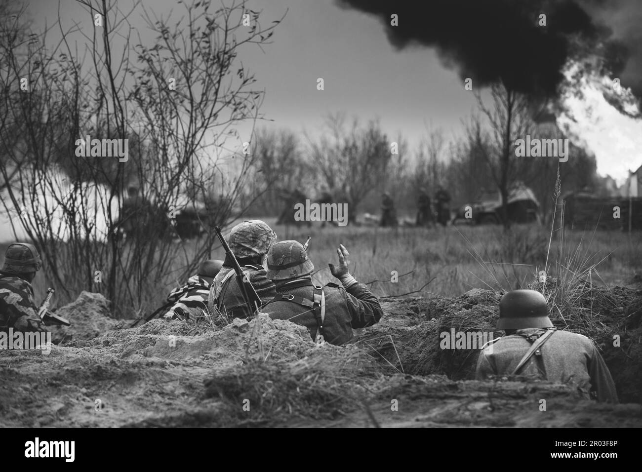 Fight Against Combat Vehicle. Reenactors Armed Rifles And Dressed As