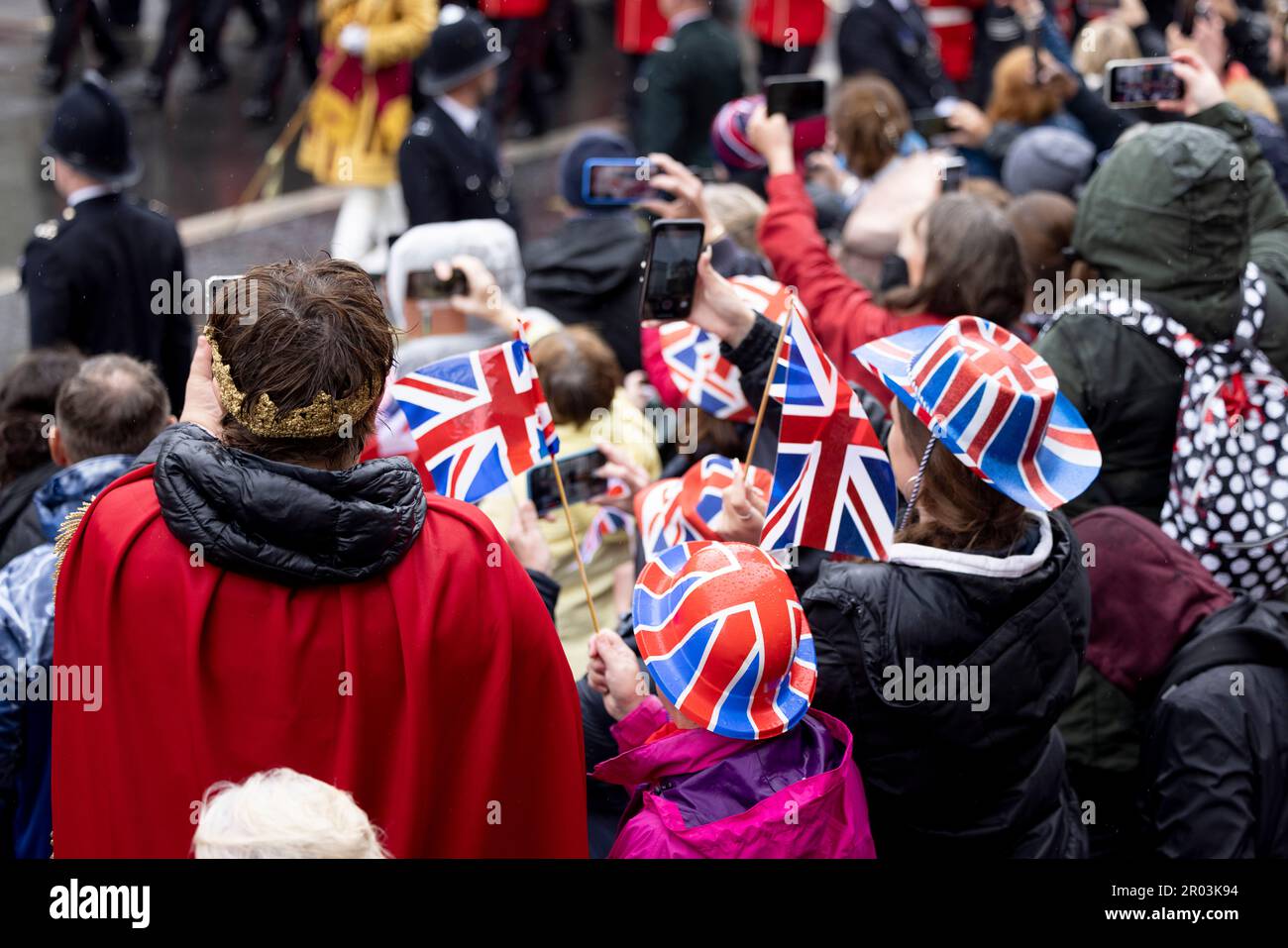 London, UK. 06th May, 2023. Royal fans are seen wearing Union Jack hats while watching the royal family parade after the coronation service of King Charles III. King Charles III leads the rest of the royal family to join on a parade to Buckingham Palace after the coronation service at Westminster Abbey. Credit: SOPA Images Limited/Alamy Live News Stock Photo
