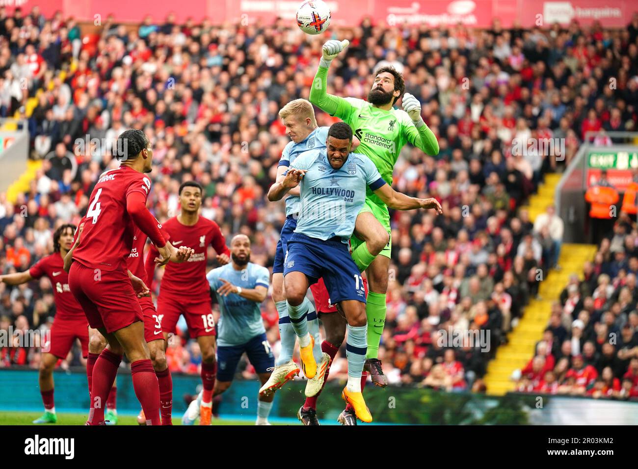 Liverpool goalkeeper Alisson Becker (right) punches the ball clear from danger during the