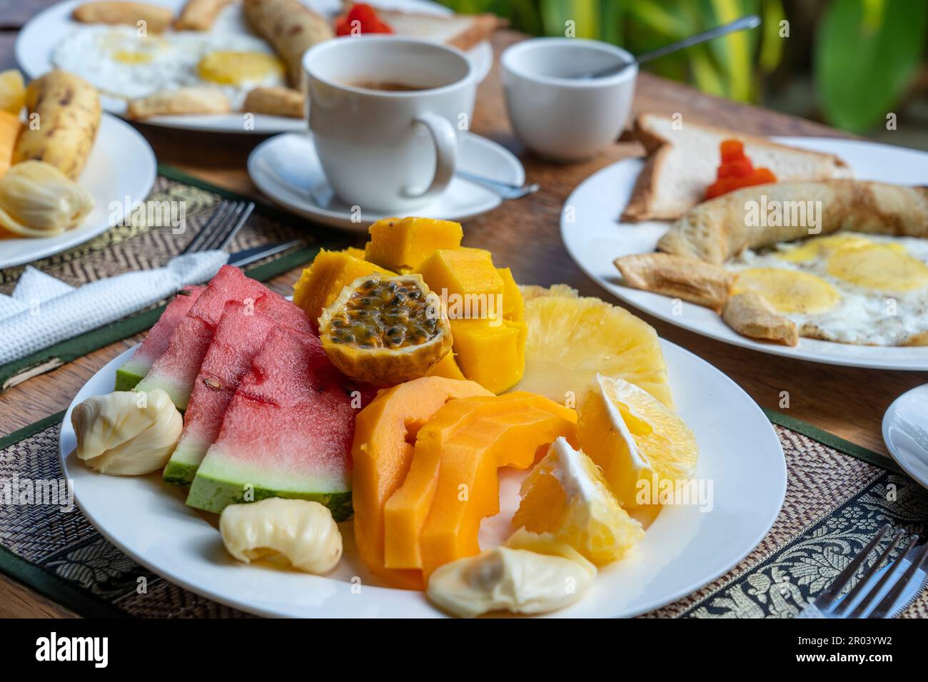 Tropical breakfast of fruit, coffee and scrambled eggs and banana