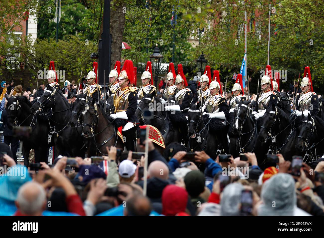 Military procession makes its way down the Mall following King Charles III and Queen Camilla's coronation at Westminster Abbey on May 6, 2023 in London England, UK On May 6 thousands form around the world line the traditional but abbreviated route between Buckingham Place and Westminster Abbey during the Coronation of King Charles III and Queen Camilla, In keeping with tradition, His Majesty's vestments will feature articles worn during previous coronations dating back to 1821, The procession from Buckingham Palace to Westminster Abbey will feature the Diamond Jubilee State Coach and the G Stock Photo