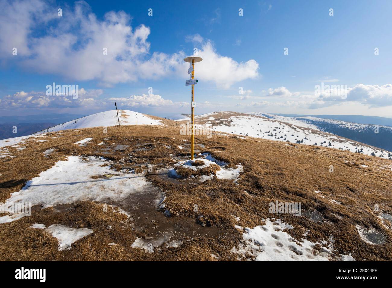 Ostredok, Velka Fatra, Slovakia, Europe - guidepost, signpost, signboard and board on the top of mountain and hill. Snow is melting in the spring. Sun Stock Photo