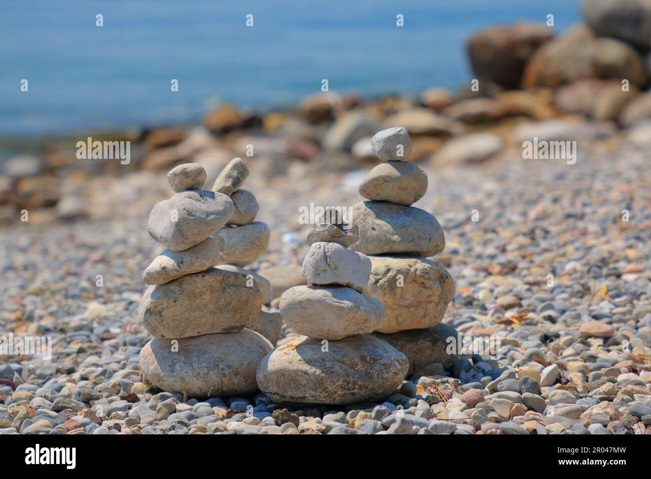 Large pebbles, collected as a composition a la 'Stonehenge' on Lake Garda for the opening of the beach season. Stock Photo