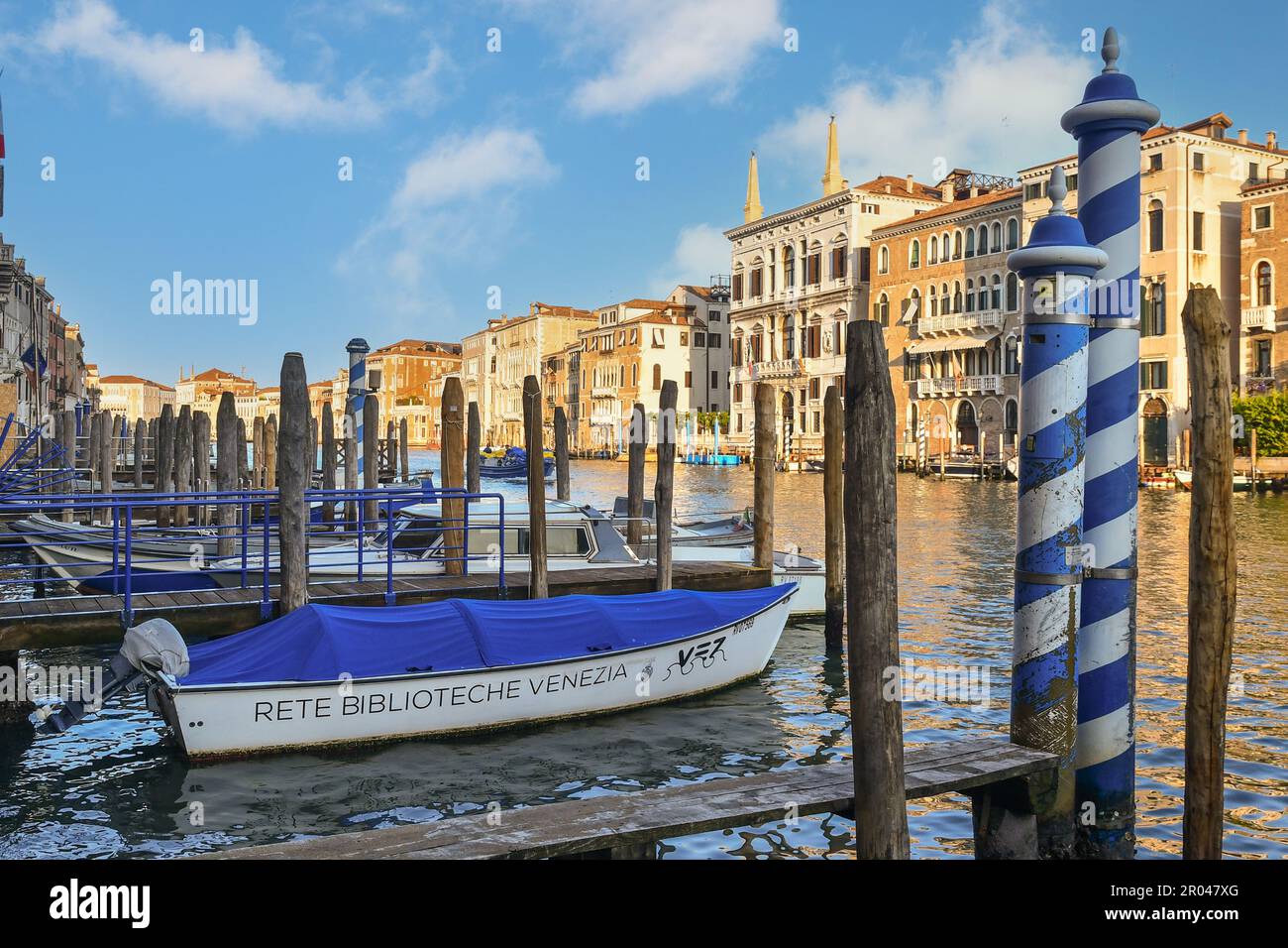 Venice Library Network boat moored on the Grand Canal with Papadopoli Palace in the background, Venice, Veneto, Italy Stock Photo