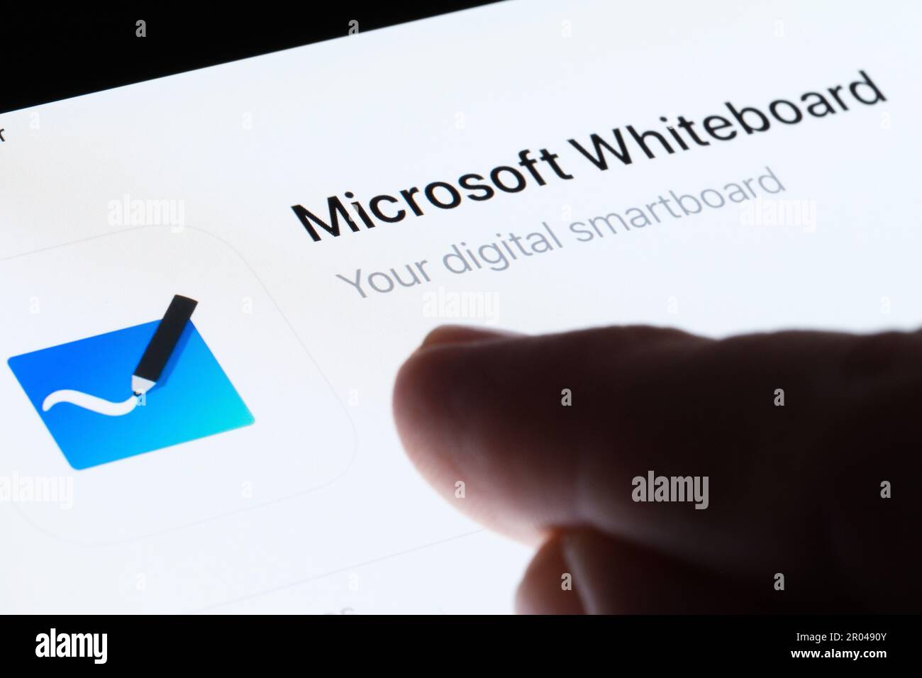 Microsoft Whiteboard app seen in App Store on the screen of ipad and blurred finger pointing at it. Selective focus. Stafford, United Kingdom, May 6, Stock Photo